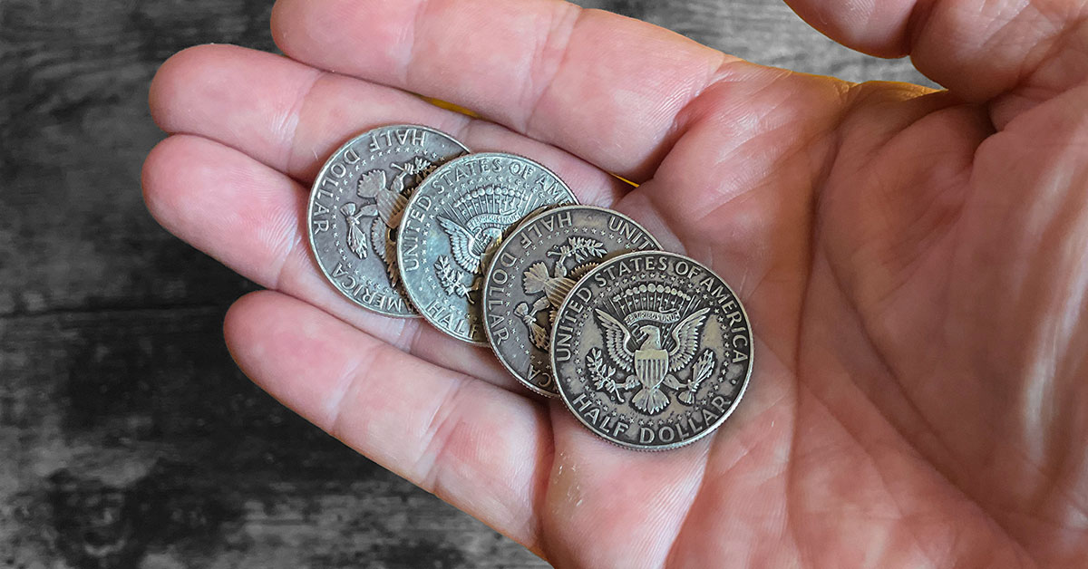 The Other Kind of Magic – Coin Practice and Sleight of Hand Tarnished silver coins in hand used for practicing sleight of hand and coin magic