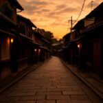A quiet cobblestone street in a traditional Japanese neighborhood at sunset, evoking solitude, reflection, and the spirit of travel.