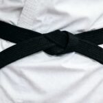 Close-up of a black belt tied around a gi