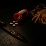 Rusty weapon, spilled pills, and fast food on table — symbolic real self-defense metaphor